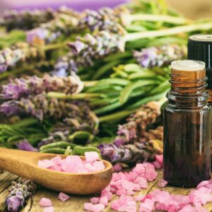 Fresh lavender, essential oil and bath salt on wooden background