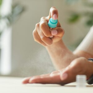 Woman Spraying Hand Sanitizer Close Up