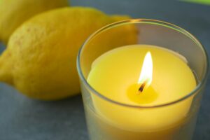 yellow color candle and lemon on black background